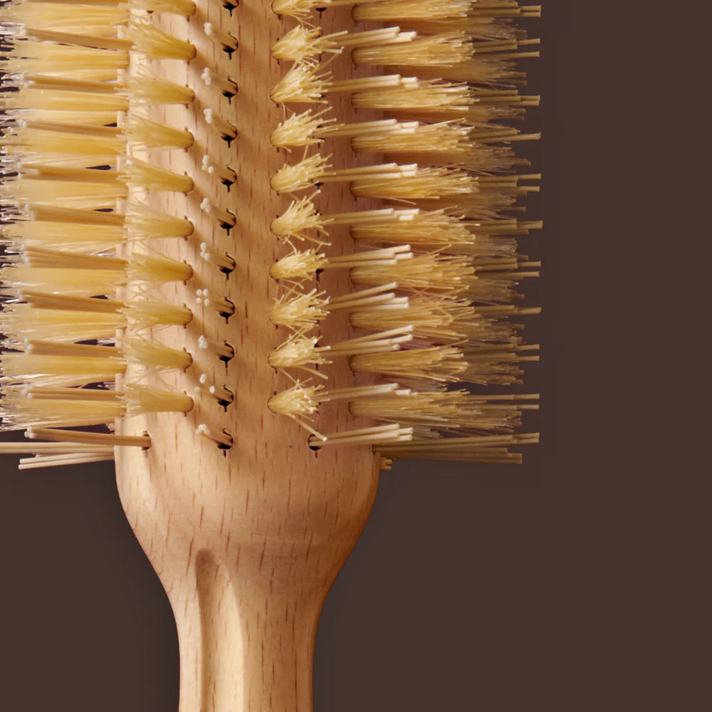 Wooden brush with bristle head on a brown background