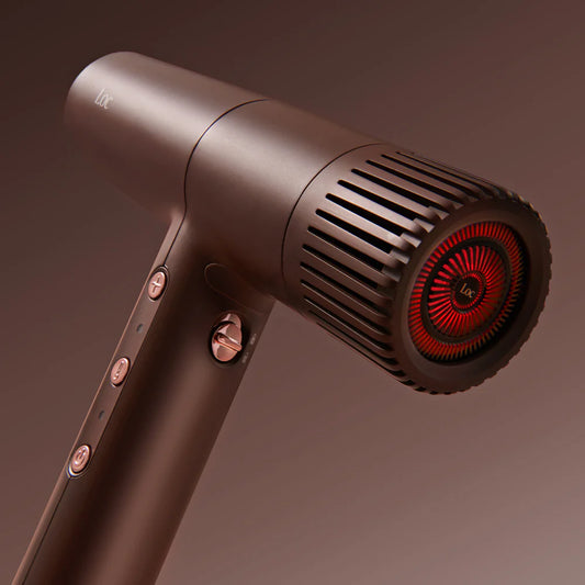 Hair dryer with a metallic finish and red interior on a brown background