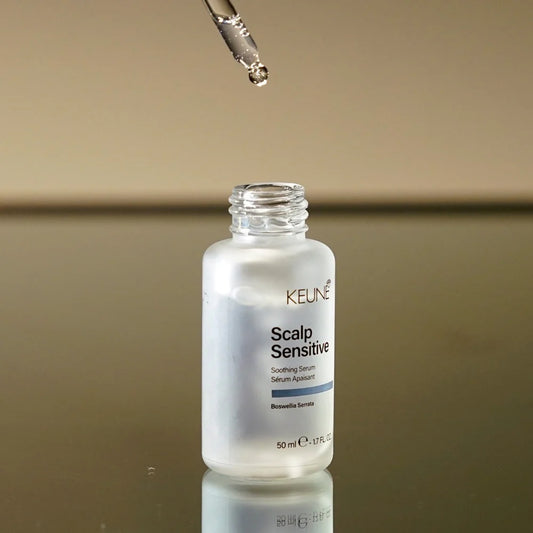 Keune Scalp Sensitive serum bottle with dropper on a reflective surface