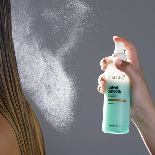 Keune velvet smooth bottle misting onto hair