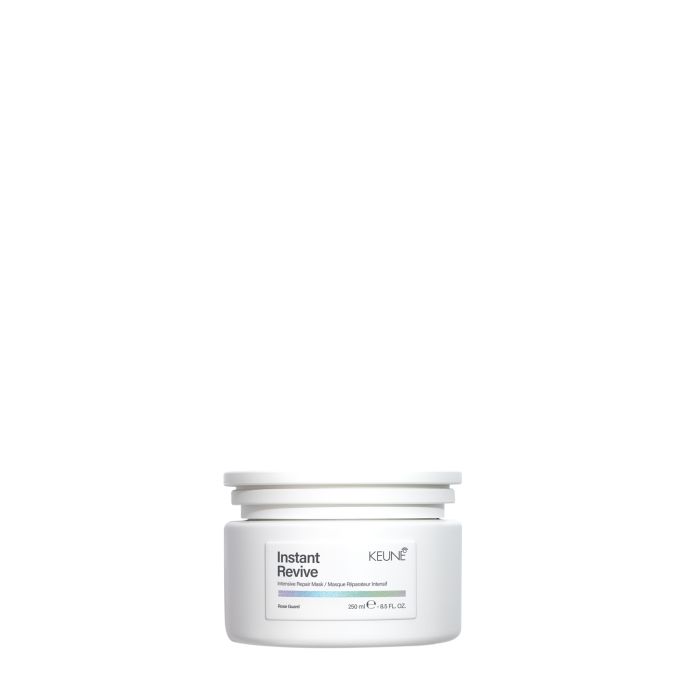 A white plastic jar of KEUNE Instant Revive Hair Reviver on a solid white background.