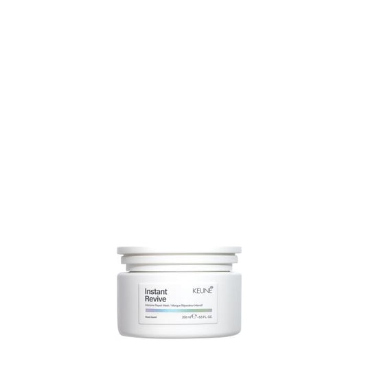 A white plastic jar of KEUNE Instant Revive Hair Reviver on a solid white background.