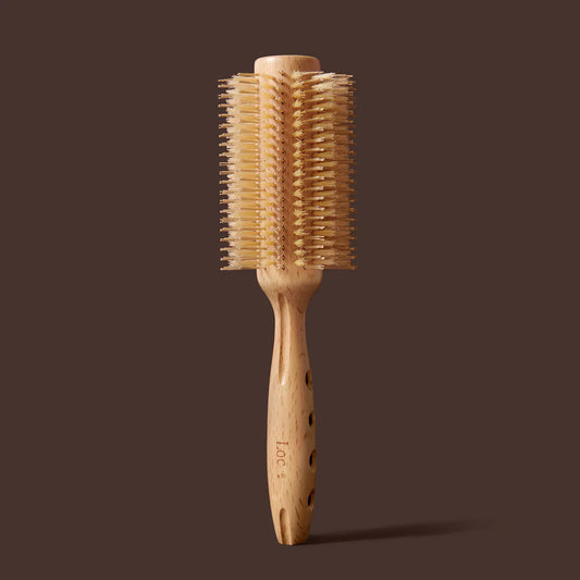 Wooden hairbrush with bristle head on a brown background