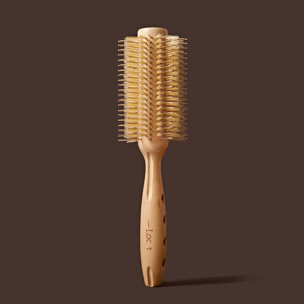 Wooden hairbrush with bristle head on a brown background