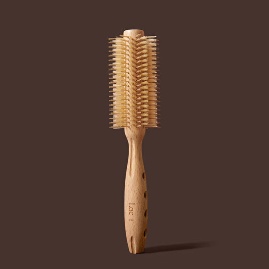Wooden hairbrush with bristle head on a brown background