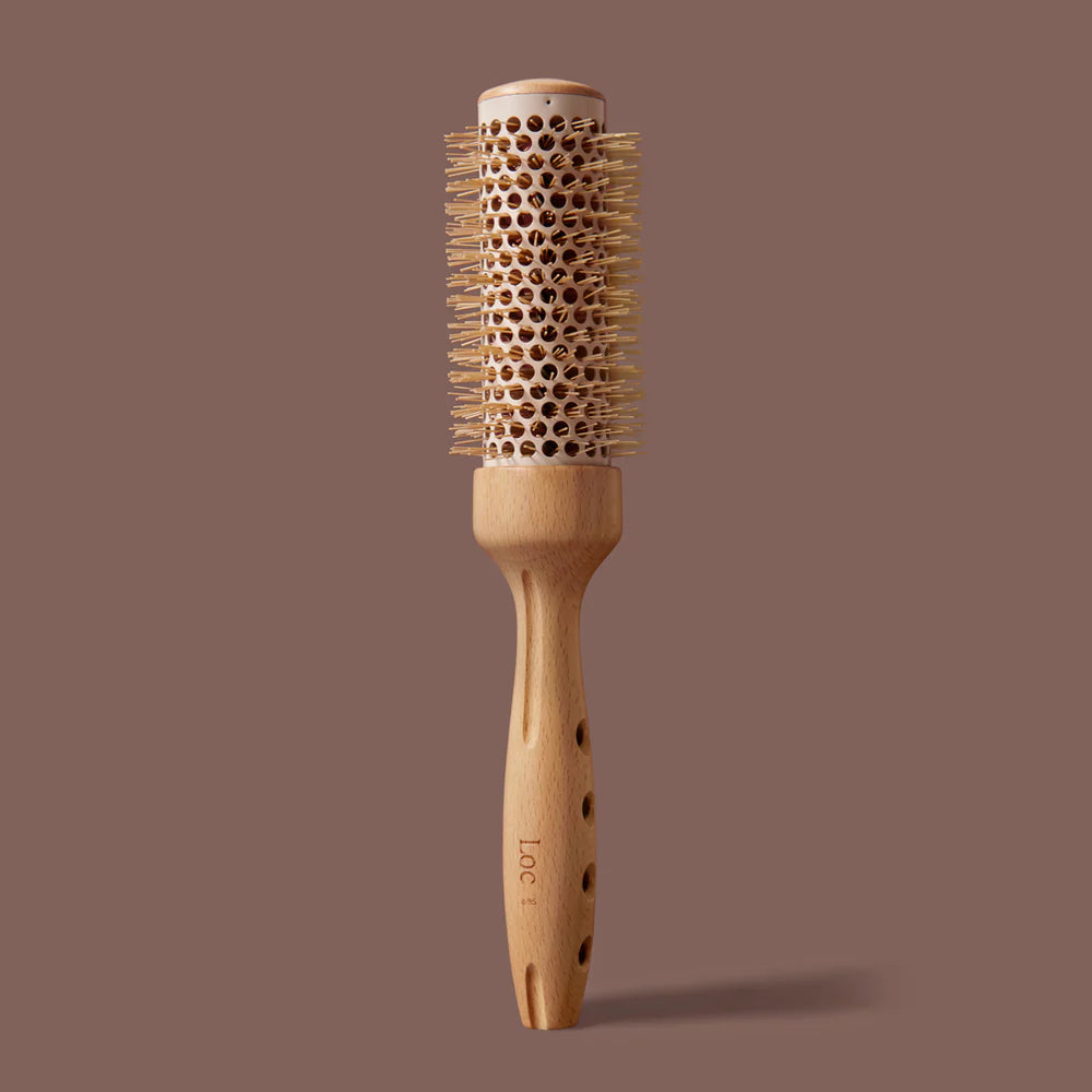 Wooden hairbrush with bristle head on a brown background