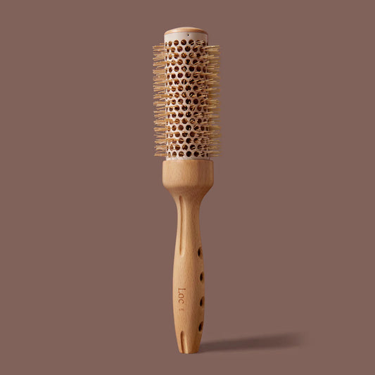 Wooden hairbrush with bristle head on a brown background