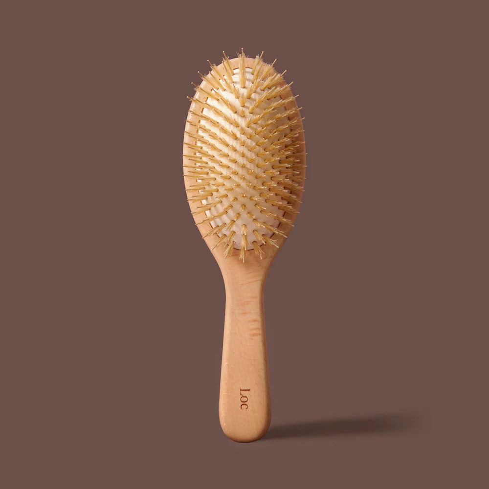 Wooden hairbrush on a brown background