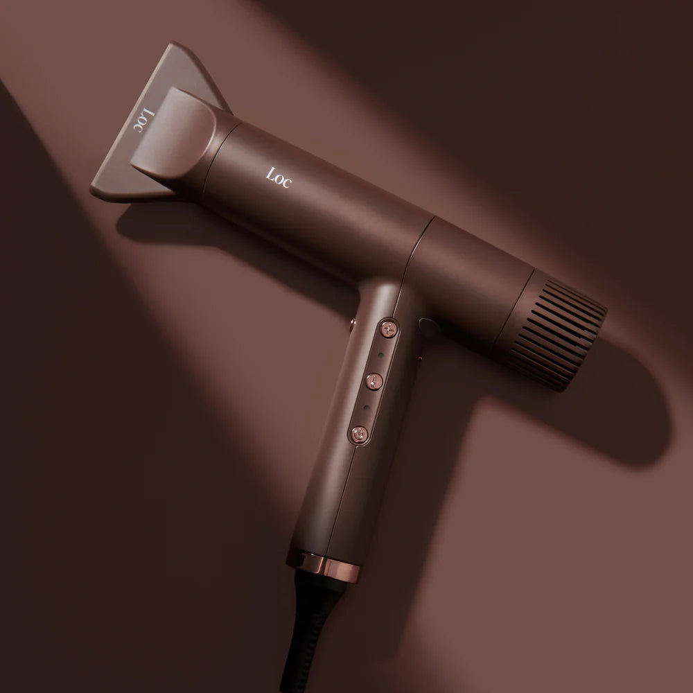 Hair dryer with attachments on a brown background