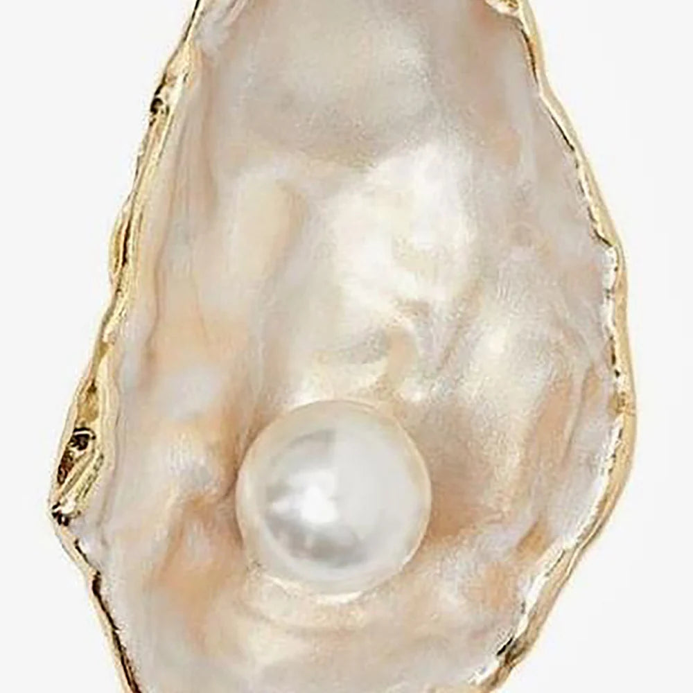 Pearl inside an oyster shell on a white background