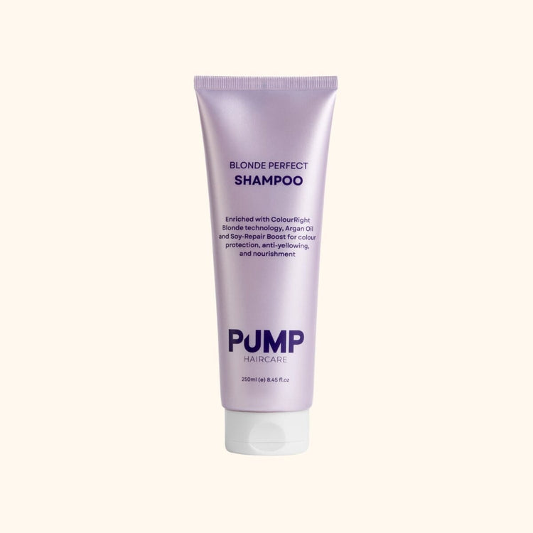 Purple shampoo bottle labeled ' Pump Blonde Perfect Shampoo' on a white background