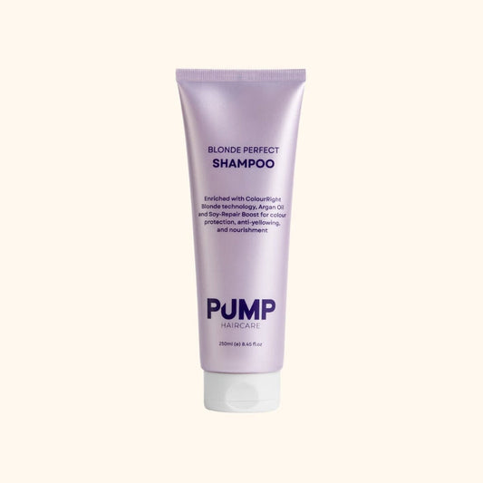 Purple shampoo bottle labeled ' Pump Blonde Perfect Shampoo' on a white background